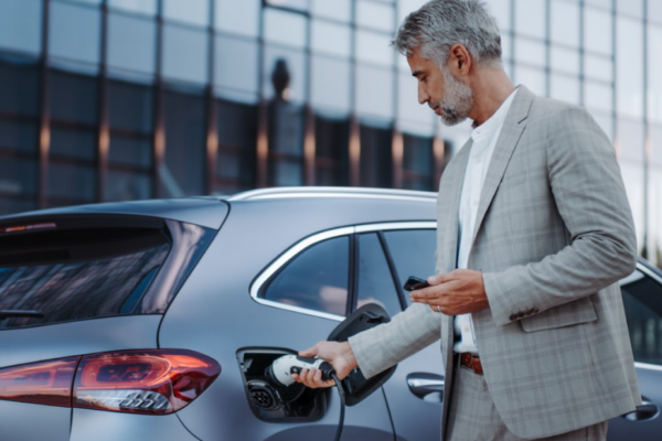 A man fueling up an electric vehicle