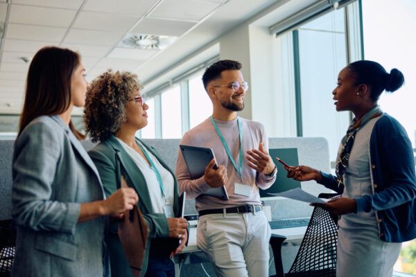 A group of people talking in an office