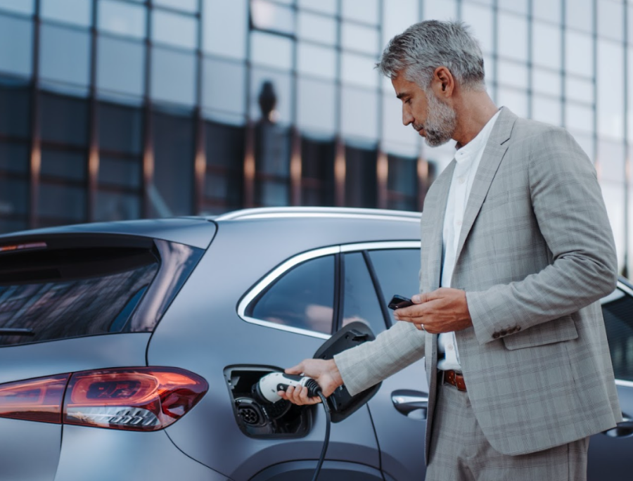 A man fueling up an electric vehicle