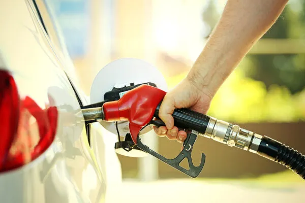 A car refueling at a service station with a fuel card