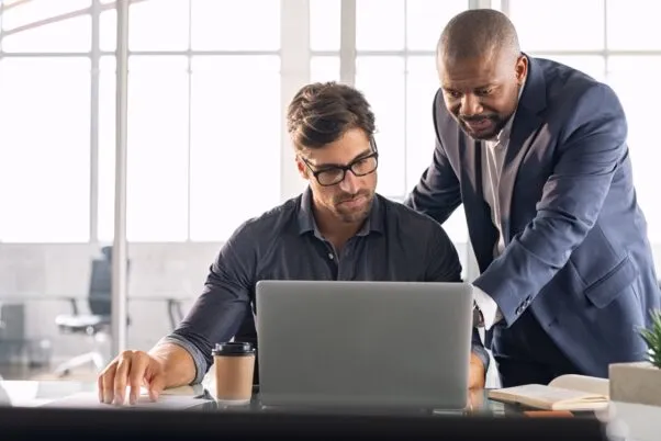 Business owners reviewing fuel card usage data on a computer, analysing expenses and trends for better cost management