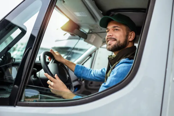 A truck driver navigating the road, focused on the journey ahead