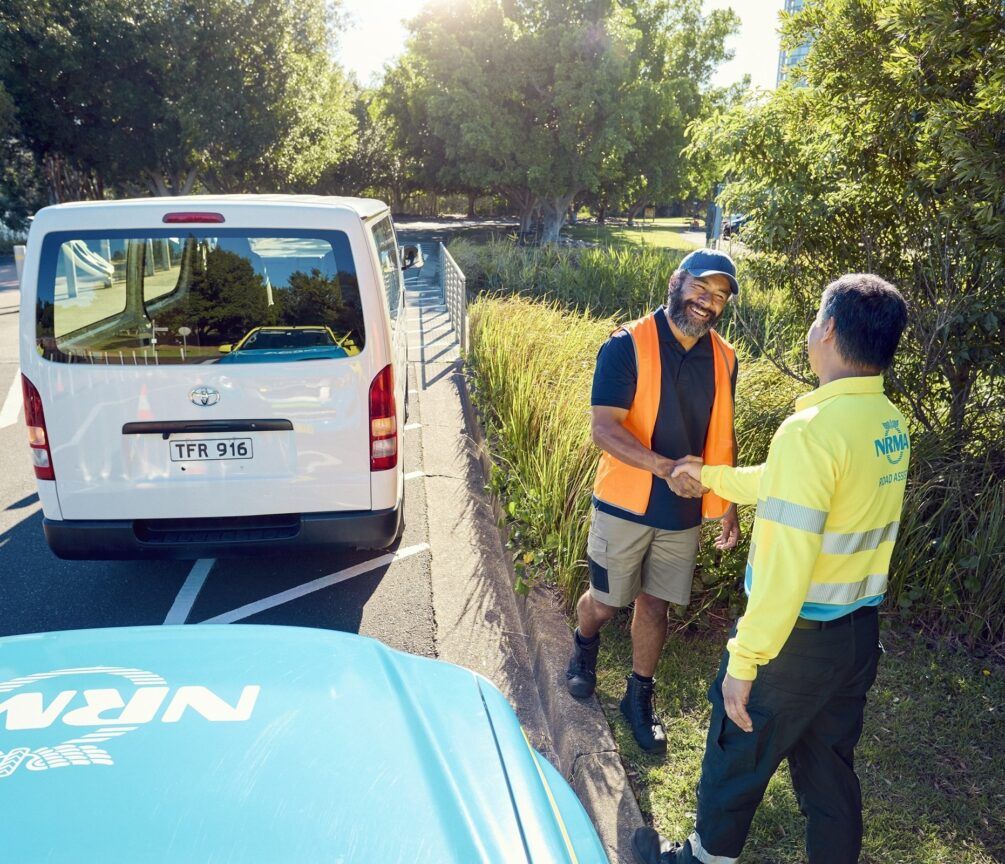 Roadside assistance technician helping a driver with a broken-down car