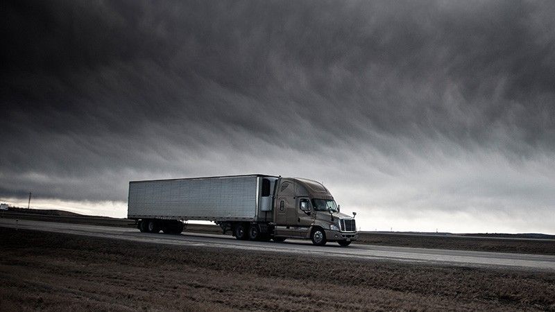 truck drives through stomry clouds