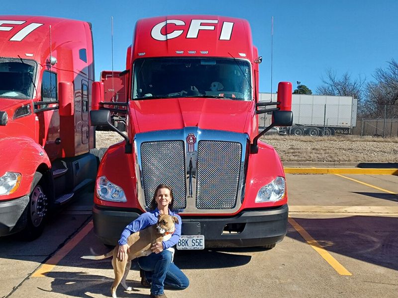 Endrea and her dog, Sanza in front of their CFI truck