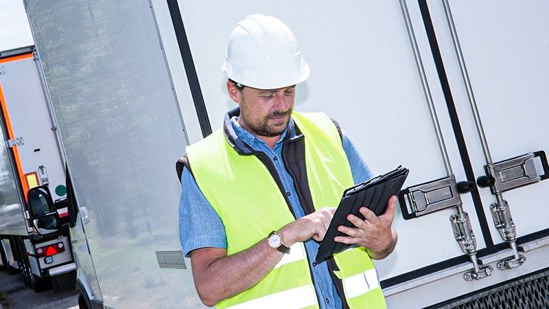 driver looks at tablet