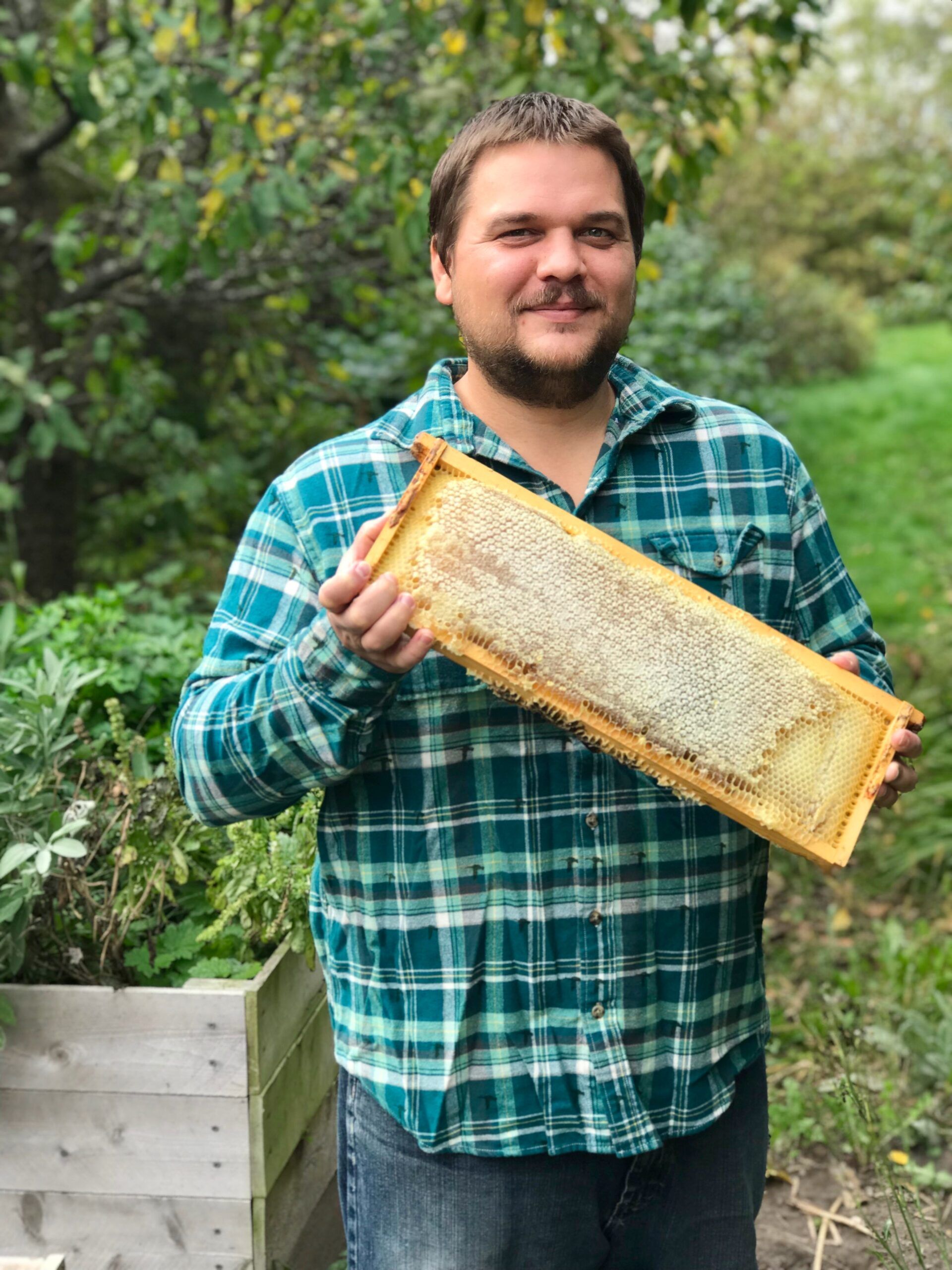 Karl harvesting honey on the homestead