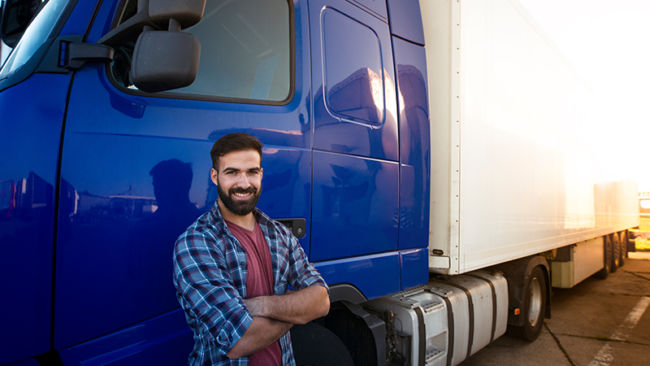 Trucker in front of vehicle fleet factoring