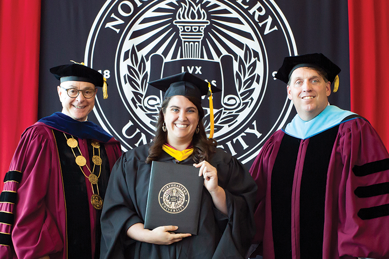 WEXer Alaina Cellini holding her fresh-off-the-press Masters in Data Analytics degree from Roux
