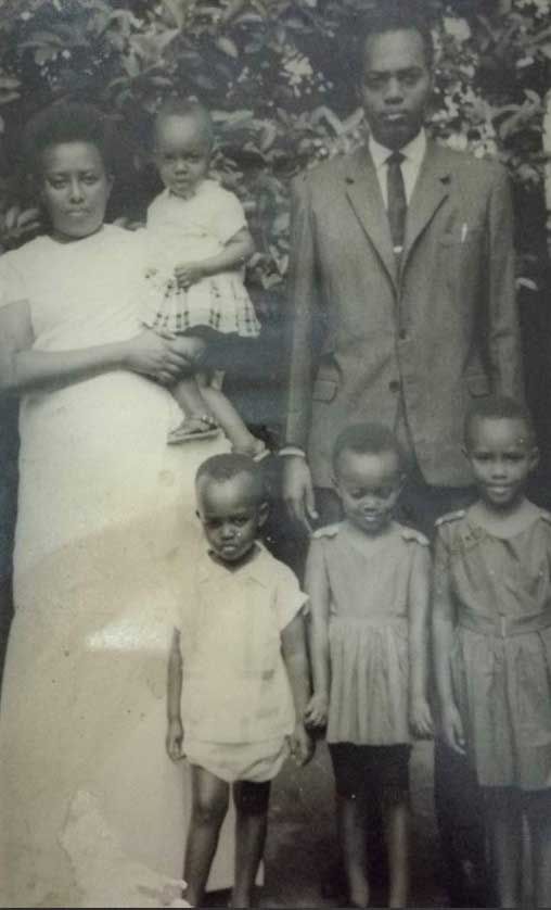 Ruvakubusa with her parents and siblings, she is in her mother’s arms at age 2
