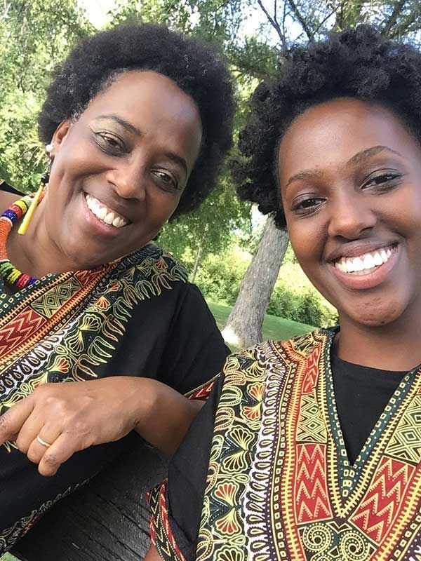 Ruvakubusa and her daughter in shirts designed and sewn by Ruvakubusa