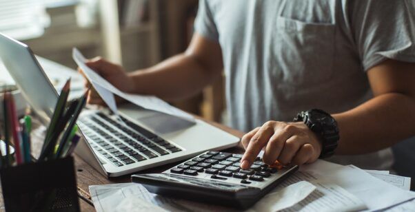 man going over finances on computer