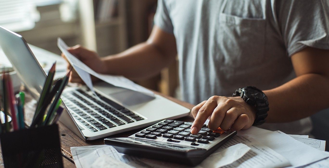 man going over finances on computer