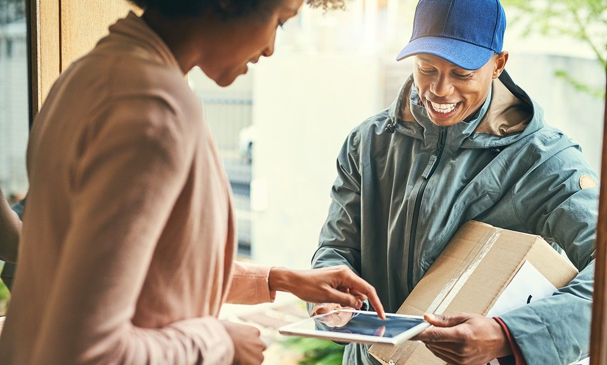 delivery man smiling with customer