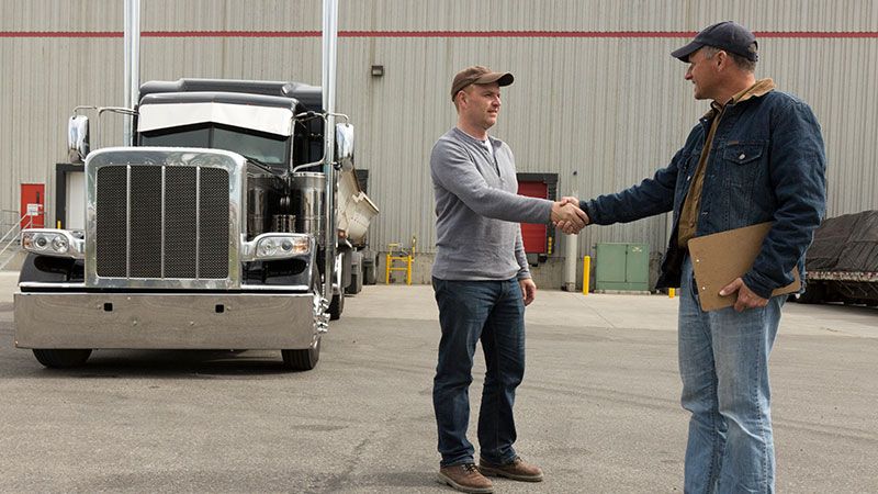 driver and manager shake hands