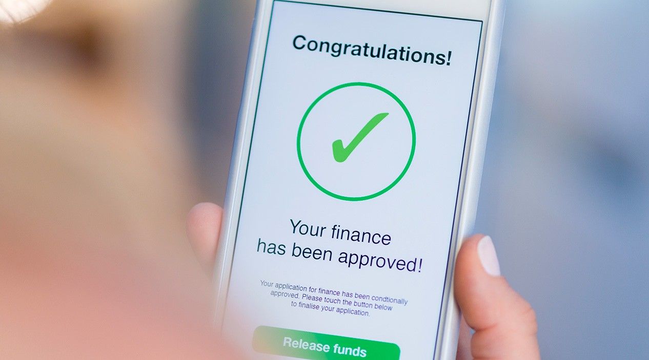 mobile phone shows approval of loan message