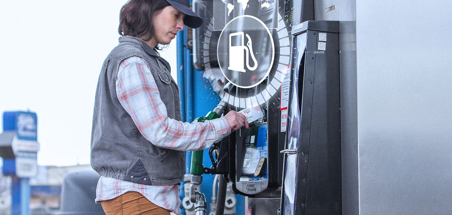 woman truck driver uses fleet card from WEX to purchase gas