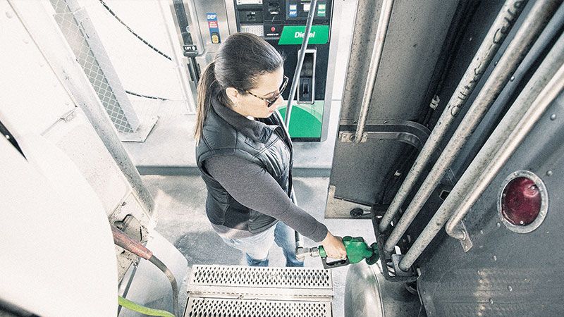 driver filling up truck fuel tank