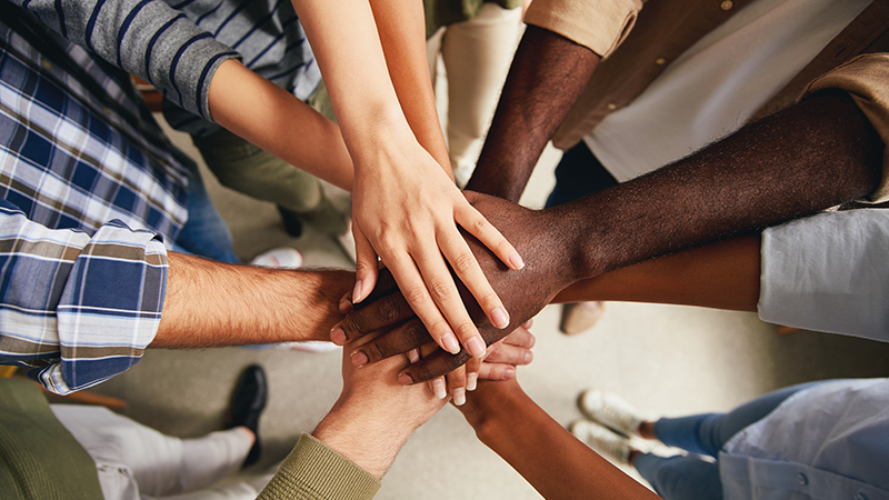 diverse group of hands cheering together