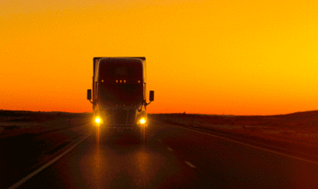Front of truck with sun set in the background