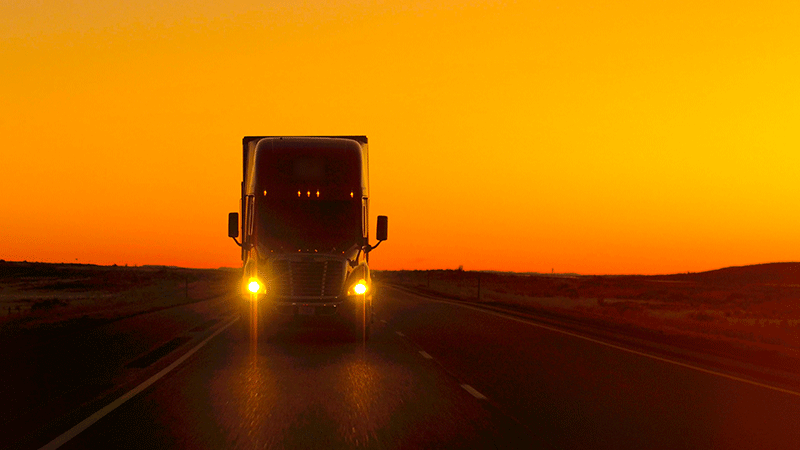 Front of truck with sun set in the background