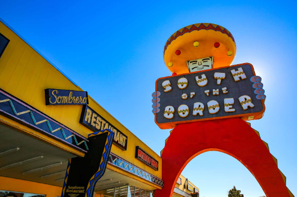 South of the Boarder truck stop with their mascot holding a sign outside of the Sombrero restaurant.