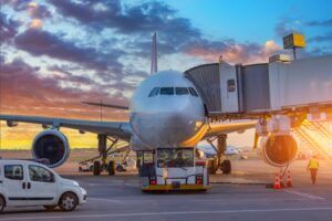 Commercial aircraft at airport gate illustrating airline failure and supplier risk in the travel industry