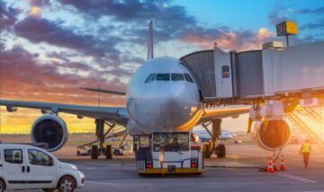 Commercial aircraft at airport gate illustrating airline failure and supplier risk in the travel industry